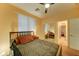 Cozy bedroom featuring a ceiling fan, and an adjacent bathroom at 17009 S Coleman St, Phoenix, AZ 85045