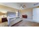 Spacious bedroom with ceiling fan, neutral walls, and large bed with matching end tables at 17009 S Coleman St, Phoenix, AZ 85045