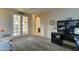 Well-lit carpeted room with French doors that allow ample light and access to the home's upper level at 17009 S Coleman St, Phoenix, AZ 85045