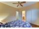 Cozy bedroom with ceiling fan, closet with sliding doors, and an adjacent bathroom at 17009 S Coleman St, Phoenix, AZ 85045