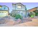 Charming two-story home with desert landscaping, decorative rocks and walkway leading to the front door at 17009 S Coleman St, Phoenix, AZ 85045