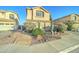 Inviting home with desert landscaping, colorful blooming bushes, and a walkway leading to the front door at 17009 S Coleman St, Phoenix, AZ 85045