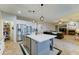 Open concept kitchen with an island, stainless steel appliances, and connection to the living room at 17009 S Coleman St, Phoenix, AZ 85045