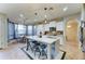 Bright kitchen featuring a large island with seating, pendant lights, and stainless steel appliances at 17009 S Coleman St, Phoenix, AZ 85045