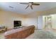 Comfortable living room with a ceiling fan, TV, and carpeted flooring at 17009 S Coleman St, Phoenix, AZ 85045