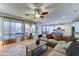 Bright living area with large windows, a ceiling fan, and a view of the kitchen, perfect for entertaining guests at 17009 S Coleman St, Phoenix, AZ 85045