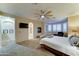 Spacious main bedroom featuring a fireplace, ceiling fan, and access to an ensuite bathroom at 17009 S Coleman St, Phoenix, AZ 85045