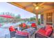 Outdoor covered patio with seating, view of the pool, outdoor kitchen, and fire pit at 17009 S Coleman St, Phoenix, AZ 85045
