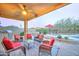 Outdoor covered patio features ample seating, outdoor kitchen, bar seating and a view of the pool at 17009 S Coleman St, Phoenix, AZ 85045