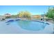 Backyard pool and spa are surrounded by desert landscaping and include a nearby patio area at 17009 S Coleman St, Phoenix, AZ 85045