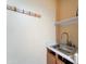 A utility sink with cabinets underneath and a wall-mounted shelf above it at 17009 S Coleman St, Phoenix, AZ 85045