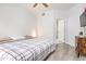 Comfortable bedroom with a large window, ceiling fan, and wood-look flooring at 1701 E Colter St # 151, Phoenix, AZ 85016