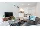 Bright living room featuring modern furnishings, stylish décor, and an open layout leading to the kitchen at 1701 E Colter St # 151, Phoenix, AZ 85016