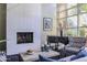 Inviting living room featuring a modern fireplace, elegant piano, and large windows at 1701 E Colter St # 151, Phoenix, AZ 85016