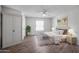 Bright bedroom with large window, ceiling fan, and hardwood floors at 17238 N 107Th Ave, Sun City, AZ 85373