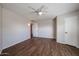 An open bedroom with wood-look floors features neutral walls, a ceiling fan, and built-in lighting at 17238 N 107Th Ave, Sun City, AZ 85373