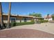 Charming single-story home with manicured landscaping, gravel yard, and view of a church at 17238 N 107Th Ave, Sun City, AZ 85373