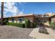 Charming single-story home with desert landscaping and lush green hedges, perfect for low-maintenance living at 17238 N 107Th Ave, Sun City, AZ 85373