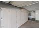 Attached garage featuring extensive storage cabinets and access to the laundry room at 17238 N 107Th Ave, Sun City, AZ 85373