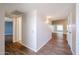 Bright hallway with wood-look flooring, leading to the bedrooms, living room, and kitchen at 17238 N 107Th Ave, Sun City, AZ 85373