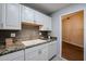 This kitchen features white cabinets and granite countertops at 17238 N 107Th Ave, Sun City, AZ 85373