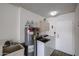 Well-equipped laundry room with washer, dryer, utility sink, and storage cabinets at 17238 N 107Th Ave, Sun City, AZ 85373