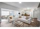 Bright living room with white sofa, open to dining room with pendant lighting at 17238 N 107Th Ave, Sun City, AZ 85373