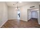 Spacious living room featuring wood-look flooring, chandelier and access to the kitchen at 17238 N 107Th Ave, Sun City, AZ 85373