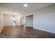 Bright, open living room with wood-look flooring, neutral walls and decorative chandelier at 17238 N 107Th Ave, Sun City, AZ 85373
