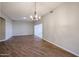 Open concept living room with decorative lighting, neutral walls and wood-look flooring at 17238 N 107Th Ave, Sun City, AZ 85373
