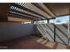 Cozy, covered patio with a tiled floor features string lights and a private, fenced-in space at 17238 N 107Th Ave, Sun City, AZ 85373