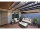 Inviting patio features comfortable seating, a pergola, and subtle string lights for relaxing evenings at 17238 N 107Th Ave, Sun City, AZ 85373