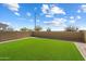 Green, newly installed back yard with block wall providing a private outdoor space at 20181 W Desert Bloom St, Buckeye, AZ 85326