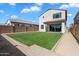 New back yard features a green lawn, a covered patio, and a block wall for a private outdoor area at 20181 W Desert Bloom St, Buckeye, AZ 85326