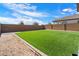 Green, newly installed back yard with block wall providing a private outdoor space at 20181 W Desert Bloom St, Buckeye, AZ 85326