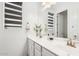 Bright bathroom features a dual sink vanity with a large mirror and modern fixtures at 22499 E Mewes Rd, Queen Creek, AZ 85142