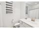 Bright bathroom with a modern vanity, neutral decor, and a horizontally-striped window shade at 22499 E Mewes Rd, Queen Creek, AZ 85142