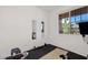 Bright exercise room featuring free weights, mirrors, and a window for natural light at 22499 E Mewes Rd, Queen Creek, AZ 85142