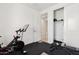 Home gym featuring a stationary bike and a weight bench set on black rubber flooring at 22499 E Mewes Rd, Queen Creek, AZ 85142