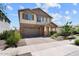 Beautiful two-story home with stone accents, a spacious driveway, and well-maintained landscaping at 22499 E Mewes Rd, Queen Creek, AZ 85142