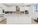 Bright kitchen with white cabinets, stainless steel appliances, and a large center island, ideal for gatherings at 22499 E Mewes Rd, Queen Creek, AZ 85142