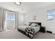 Serene primary bedroom with large windows and a comfortable bed, offering a relaxing retreat at 22499 E Mewes Rd, Queen Creek, AZ 85142