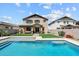Backyard pool with a manicured lawn and covered patio enhances this home's outdoor space at 22499 E Mewes Rd, Queen Creek, AZ 85142