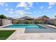 Backyard features a pristine pool, desert landscaping, and blue sky with white clouds at 22499 E Mewes Rd, Queen Creek, AZ 85142