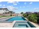 Tranquil backyard pool and spa surrounded by lush greenery and a privacy fence, ideal for outdoor enjoyment at 22499 E Mewes Rd, Queen Creek, AZ 85142