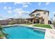 Inviting backyard oasis with a sparkling pool and lush landscaping, perfect for relaxation and entertaining at 22499 E Mewes Rd, Queen Creek, AZ 85142