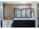 Bathroom featuring double sinks, a tub, and warm wall paper at 25386 W Darrel Dr, Buckeye, AZ 85326