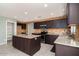 Modern kitchen with stainless steel appliances, a pantry, and granite countertops at 25386 W Darrel Dr, Buckeye, AZ 85326