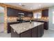 Bright kitchen with granite counters, stainless steel appliances, tile floors, and a large central island at 25386 W Darrel Dr, Buckeye, AZ 85326