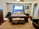 Main bedroom with a ceiling fan, sitting area, and ensuite bathroom at 25386 W Darrel Dr, Buckeye, AZ 85326